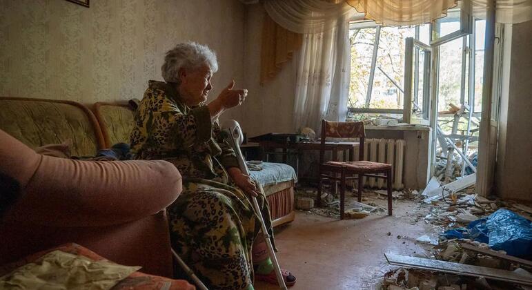 Halyna sits inside her damaged home in Kyiv, Ukraine, after a large-scale overnight attack killed and injured civilians and damaged residential buildings and other civilian infrastructure.
